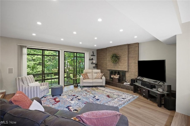 629-37 Fairington Oval, Aurora, OH 44202 - living room with light wood finished floors, recessed lighting, and a tile fireplace