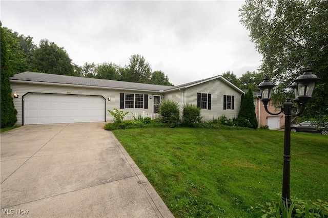 103 Beech St, Doylestown, OH 44230 - ranch-style home featuring a garage, concrete driveway, and a front lawn