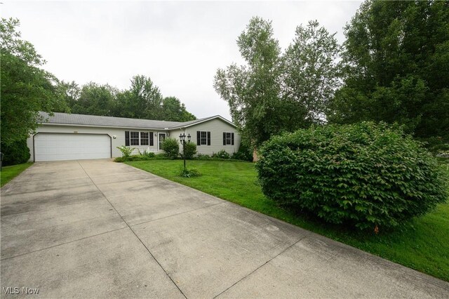 103 Beech St, Doylestown, OH 44230 - ranch-style home with an attached garage, concrete driveway, and a front yard
