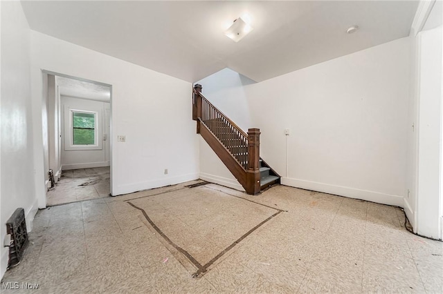 1150 W 5th St, Lorain, OH 44052 - empty room featuring baseboards and stairway