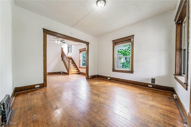 1150 W 5th St, Lorain, OH 44052 - unfurnished room with hardwood / wood-style flooring, stairs, and ceiling fan