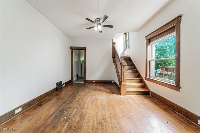1150 W 5th St, Lorain, OH 44052 - unfurnished living room featuring hardwood / wood-style floors, stairway, and ceiling fan