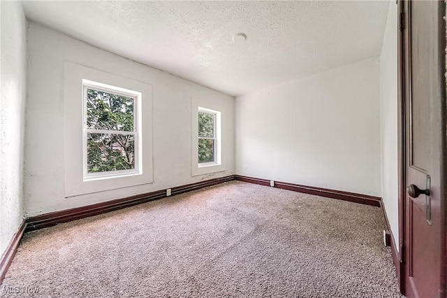 1150 W 5th St, Lorain, OH 44052 - carpeted spare room featuring a textured ceiling