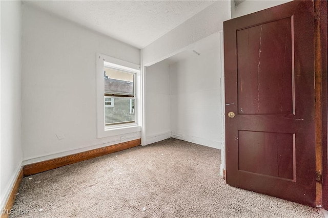 1150 W 5th St, Lorain, OH 44052 - empty room with carpet flooring and a textured ceiling