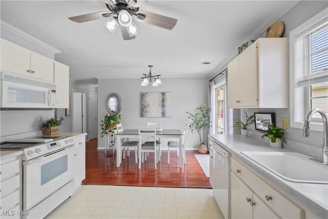 6 Wedgewood Dr, Willard, OH 44890 - kitchen with white appliances, light countertops, white cabinetry, and a chandelier