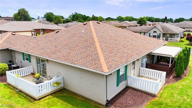 6 Wedgewood Dr, Willard, OH 44890 - rear view of property with a shingled roof, a wooden deck, a residential view, and a lawn