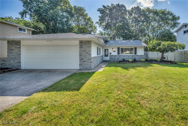 4499 Camellia Ln, North Olmsted, OH 44070 - tri-level home featuring an attached garage, concrete driveway, and brick siding