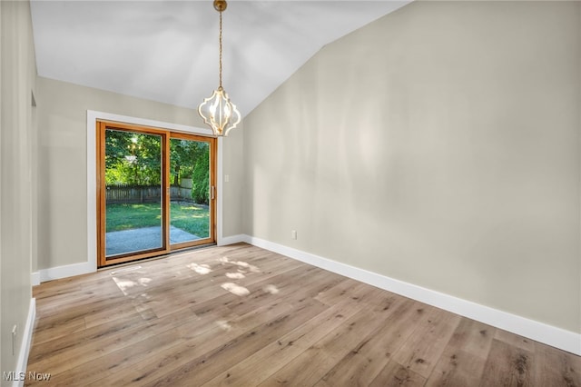 4499 Camellia Ln, North Olmsted, OH 44070 - unfurnished room featuring vaulted ceiling, a chandelier, and hardwood / wood-style floors