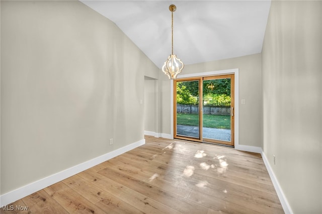 4499 Camellia Ln, North Olmsted, OH 44070 - unfurnished dining area with a chandelier, hardwood / wood-style flooring, and lofted ceiling