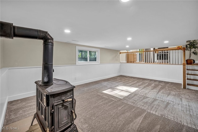 4499 Camellia Ln, North Olmsted, OH 44070 - below grade area featuring carpet, recessed lighting, a wood stove, and wainscoting