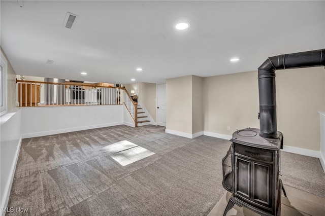 4499 Camellia Ln, North Olmsted, OH 44070 - unfurnished living room with carpet floors, a wood stove, stairway, and recessed lighting
