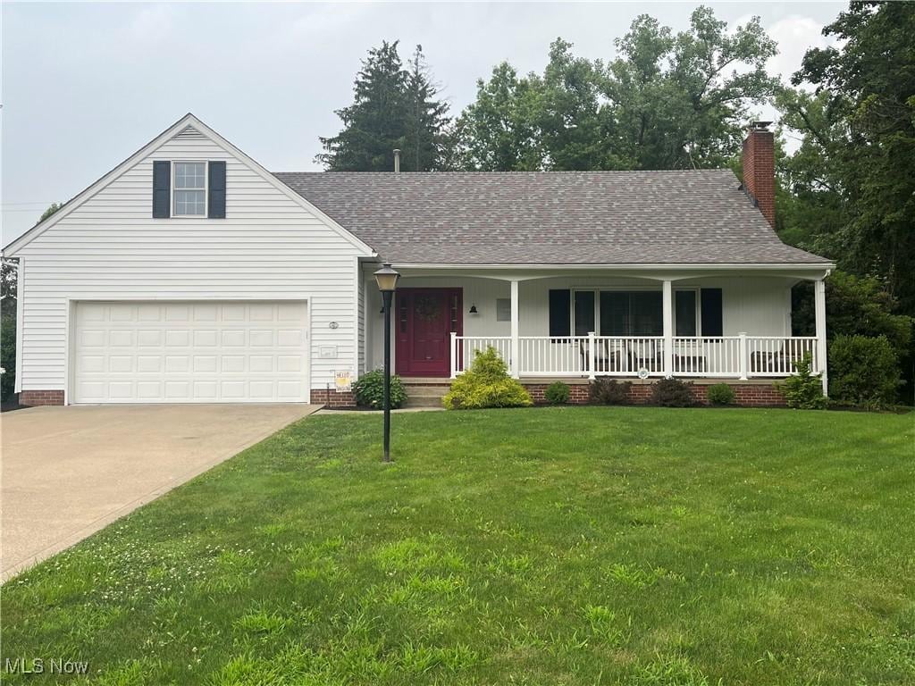 1527 Glenking Ln, Alliance, OH 44601 - view of front facade featuring a porch, a chimney, driveway, a front lawn, and roof with shingles