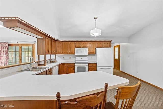 33362 State Route 833, Pomeroy, OH 45769 - kitchen with white appliances, carpet floors, light countertops, a kitchen bar, and brown cabinetry