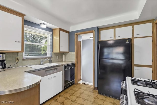 6713 Mackenzie Rd, North Olmsted, OH 44070 - kitchen with black appliances, light countertops, white cabinets, and tasteful backsplash