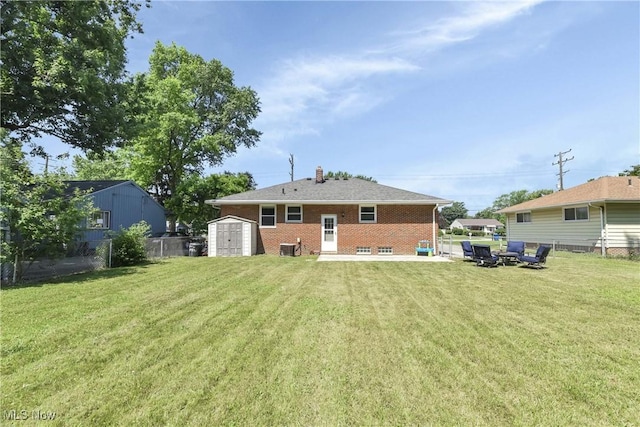 6713 Mackenzie Rd, North Olmsted, OH 44070 - back of house featuring a shed, brick siding, and a chimney