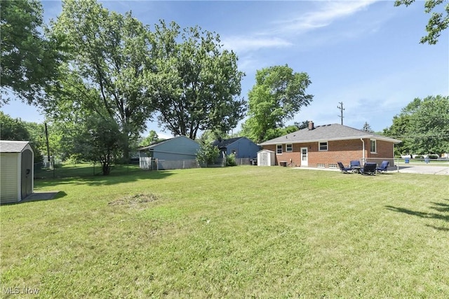 6713 Mackenzie Rd, North Olmsted, OH 44070 - view of yard featuring a storage shed and a patio area