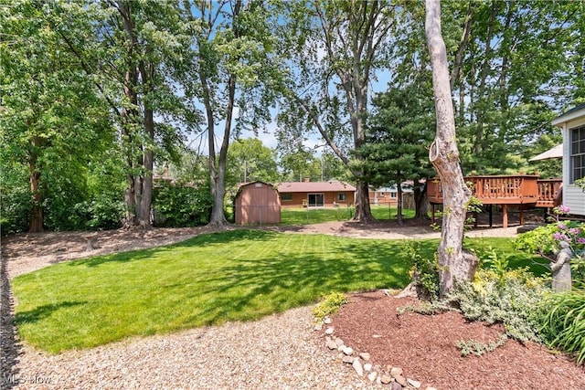 525 Bishop Pl, Berea, OH 44017 - view of grassy yard featuring a storage unit and a deck