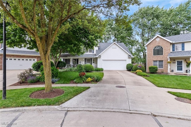 525 Bishop Pl, Berea, OH 44017 - traditional-style house with driveway, a front lawn, and a garage