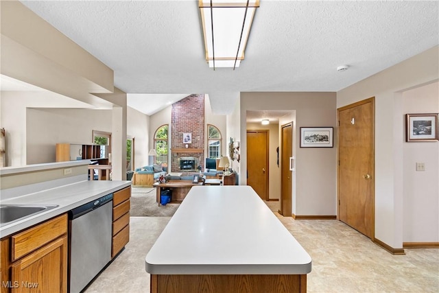 525 Bishop Pl, Berea, OH 44017 - kitchen featuring stainless steel dishwasher, light countertops, a textured ceiling, brown cabinetry, and open floor plan