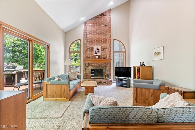 525 Bishop Pl, Berea, OH 44017 - living area with carpet, high vaulted ceiling, and a brick fireplace