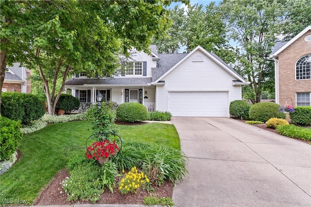 525 Bishop Pl, Berea, OH 44017 - traditional-style home featuring a garage, driveway, a front lawn, covered porch, and a shingled roof