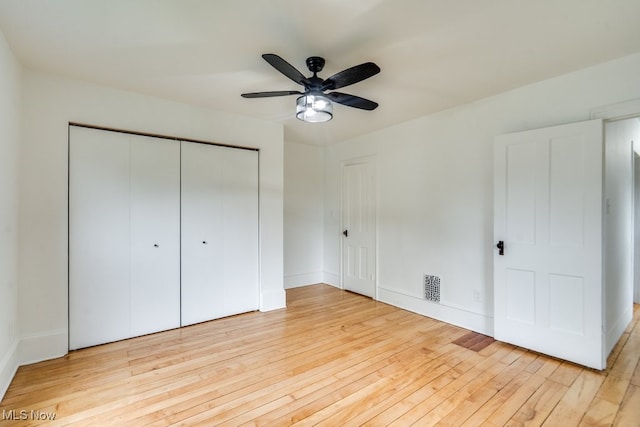 235 Elm St, Oberlin, OH 44074 - unfurnished bedroom featuring light wood-style floors, a closet, and a ceiling fan