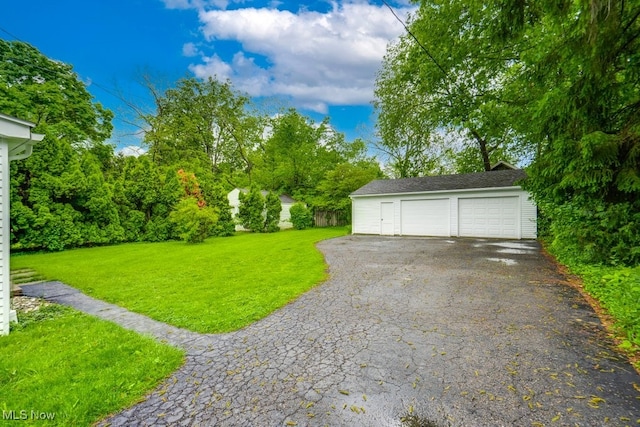 235 Elm St, Oberlin, OH 44074 - view of grassy yard with an outdoor structure and a detached garage
