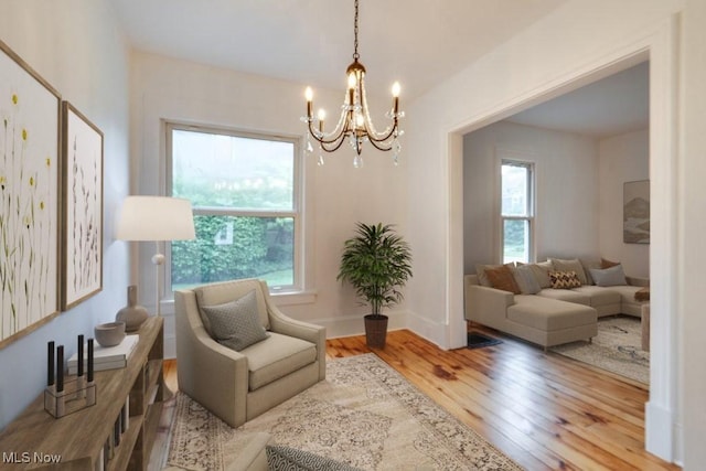 235 Elm St, Oberlin, OH 44074 - living area featuring healthy amount of natural light, a chandelier, and wood finished floors
