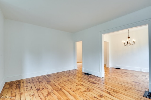 235 Elm St, Oberlin, OH 44074 - spare room with a chandelier and light wood-style floors