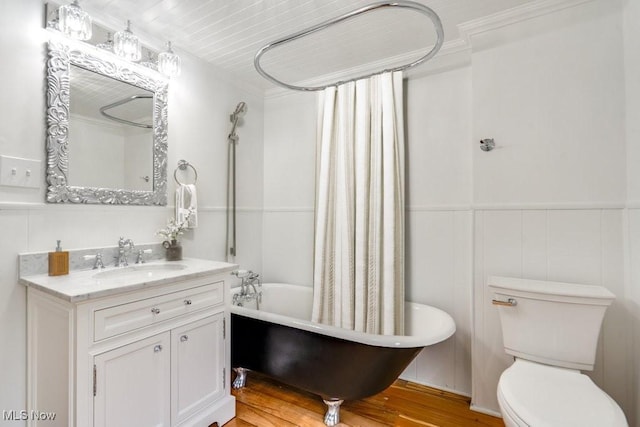 235 Elm St, Oberlin, OH 44074 - full bath with vanity, shower / tub combo, wood finished floors, and a wainscoted wall