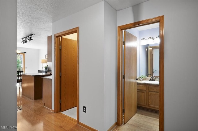 1036 Larkens Way, Medina, OH 44256 - corridor featuring light wood finished floors and a textured ceiling