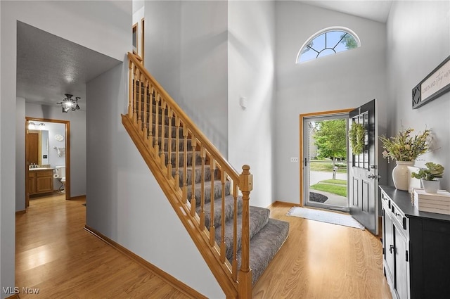 1036 Larkens Way, Medina, OH 44256 - foyer entrance with light wood-style flooring, stairway, and a towering ceiling