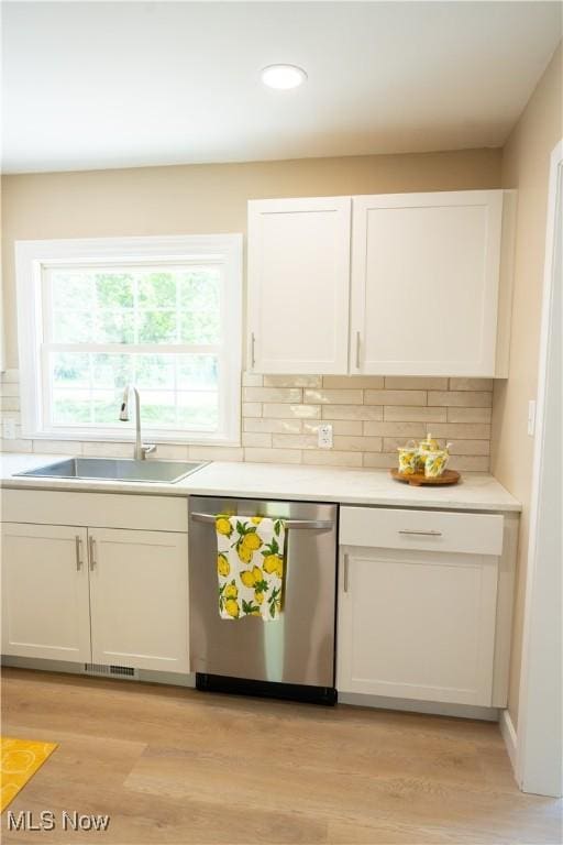 5699 Colgate Ave, Austintown, OH 44515 - kitchen with stainless steel dishwasher, white cabinetry, tasteful backsplash, light wood-style flooring, and recessed lighting
