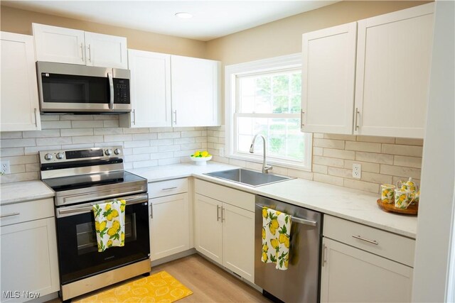 5699 Colgate Ave, Austintown, OH 44515 - kitchen featuring appliances with stainless steel finishes, light countertops, white cabinetry, and recessed lighting