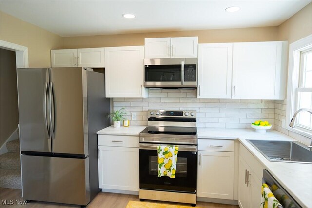 5699 Colgate Ave, Austintown, OH 44515 - kitchen with appliances with stainless steel finishes, white cabinets, light countertops, tasteful backsplash, and recessed lighting