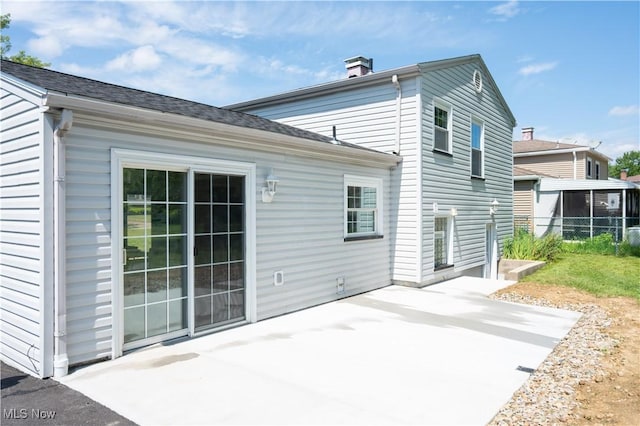 5699 Colgate Ave, Austintown, OH 44515 - rear view of house with a patio and a chimney