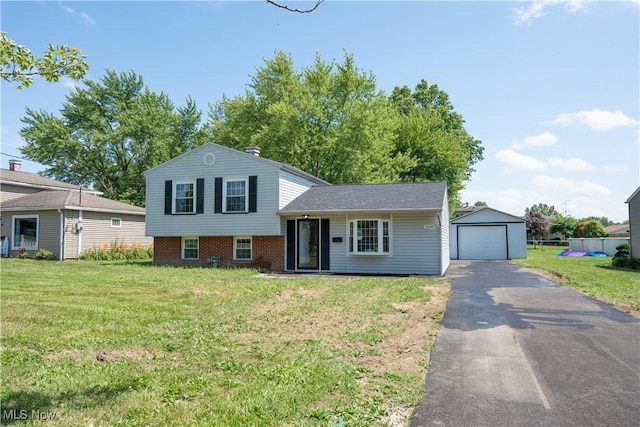 5699 Colgate Ave, Austintown, OH 44515 - view of front of house featuring asphalt driveway, a front lawn, an outbuilding, and a garage