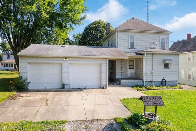 274 2nd St SW, Brewster, OH 44613 - traditional home featuring a garage, a front yard, driveway, and a porch