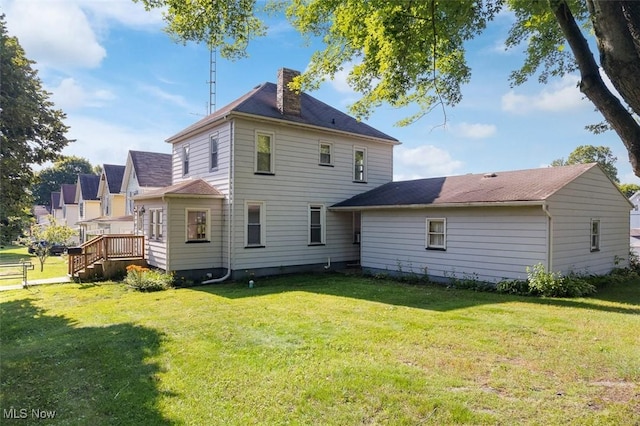 274 2nd St SW, Brewster, OH 44613 - rear view of property featuring a chimney, a yard, and a wooden deck