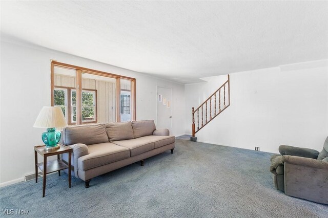 274 2nd St SW, Brewster, OH 44613 - carpeted living room featuring stairway
