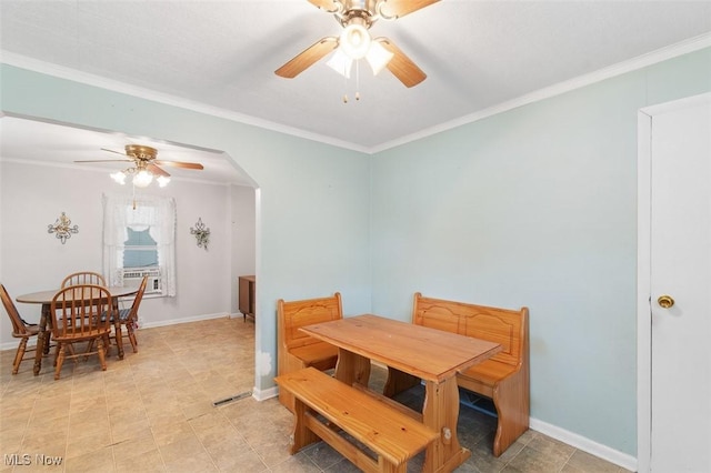 274 2nd St SW, Brewster, OH 44613 - dining room featuring ceiling fan, ornamental molding, and arched walkways