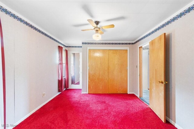274 2nd St SW, Brewster, OH 44613 - unfurnished bedroom with dark carpet, a ceiling fan, and a closet