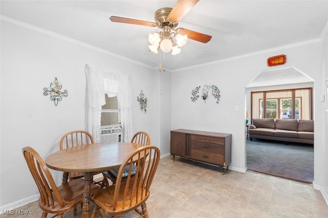 274 2nd St SW, Brewster, OH 44613 - dining area with a ceiling fan, cooling unit, arched walkways, and crown molding
