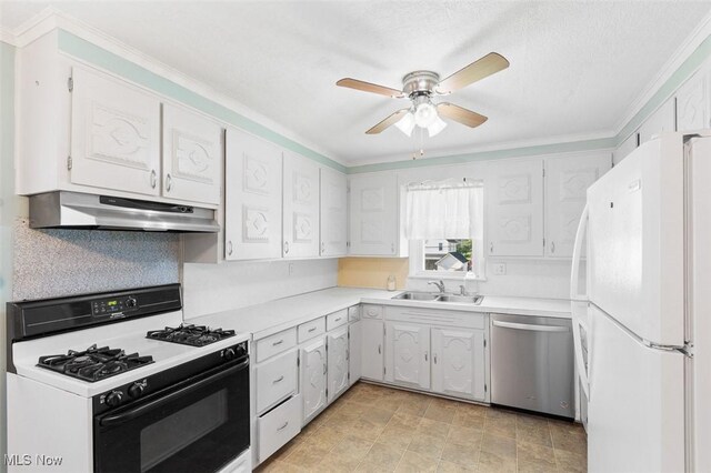 274 2nd St SW, Brewster, OH 44613 - kitchen with stainless steel dishwasher, freestanding refrigerator, under cabinet range hood, gas range oven, and crown molding