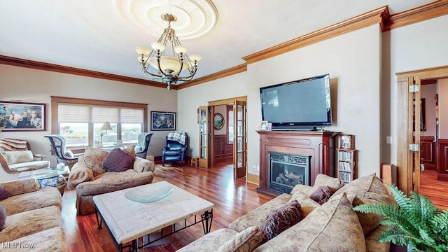 1431 Cedar Point Rd, Sandusky, OH 44870 - living room with a chandelier, crown molding, wood finished floors, and a glass covered fireplace