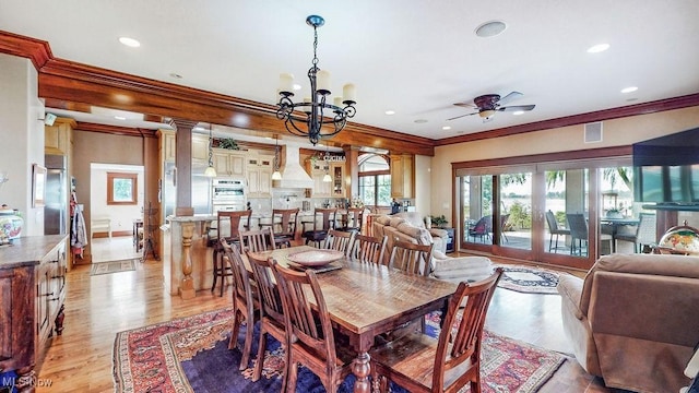 1431 Cedar Point Rd, Sandusky, OH 44870 - dining space with ornamental molding, a ceiling fan, light wood finished floors, a chandelier, and recessed lighting