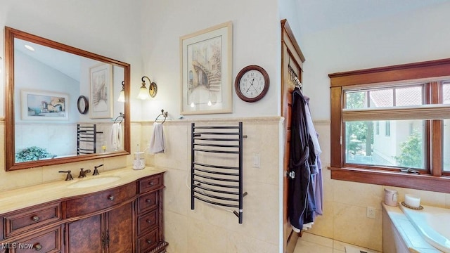1431 Cedar Point Rd, Sandusky, OH 44870 - bathroom featuring tile walls, vanity, a bath, wainscoting, and tile patterned floors