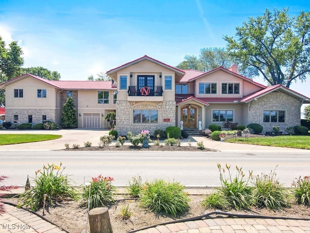 1431 Cedar Point Rd, Sandusky, OH 44870 - view of front of house with stone siding, french doors, and stucco siding