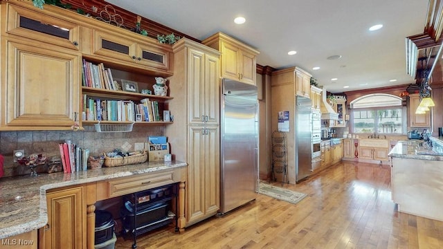 1431 Cedar Point Rd, Sandusky, OH 44870 - kitchen featuring built in fridge, backsplash, light stone countertops, recessed lighting, and light wood-style floors
