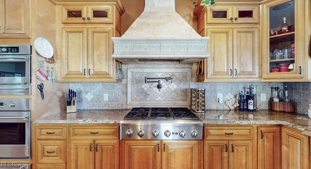 1431 Cedar Point Rd, Sandusky, OH 44870 - kitchen featuring premium range hood, appliances with stainless steel finishes, backsplash, and glass insert cabinets